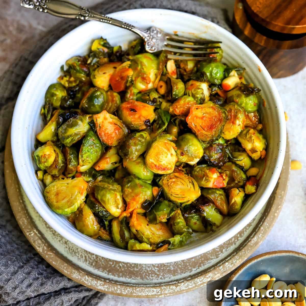 Honey Sriracha Brussels Sprouts Recipe: Sweet-Spicy Roasted Veggies 7 Honey sriracha burssel sprouts in a white bowl.