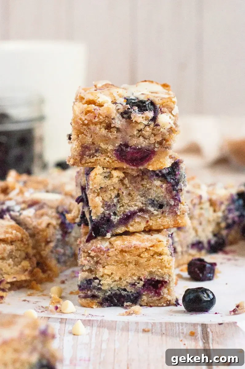 Gluten-Free Vegan Blueberry Blondies Recipe 2 Golden blueberry blondies loaded with white chocolate chips and cut into squares.