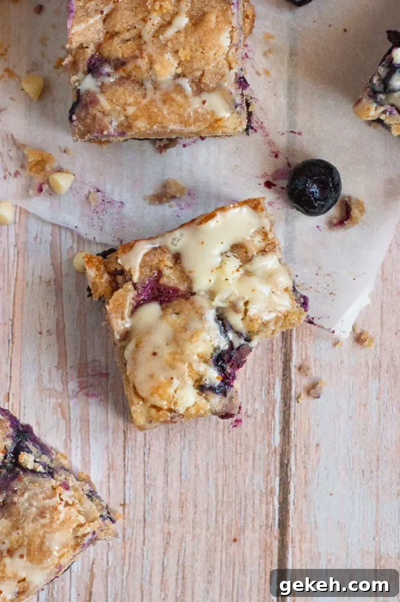 Gluten-Free Vegan Blueberry Blondies Recipe 5 Golden blueberry blondies loaded with white chocolate chips and cut into squares.