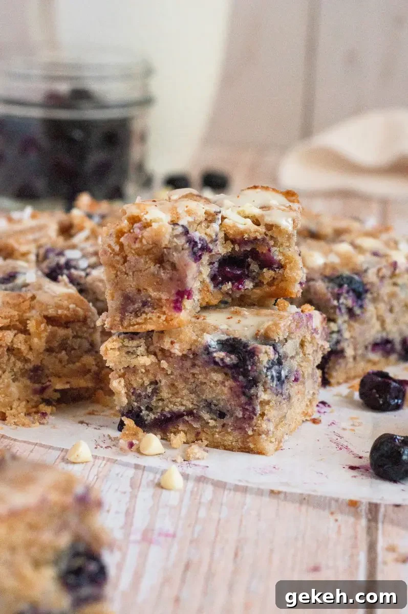 Gluten-Free Vegan Blueberry Blondies Recipe 7 Golden blueberry blondies loaded with white chocolate chips and cut into squares.