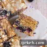 Golden blueberry blondies loaded with white chocolate chips and cut into squares.