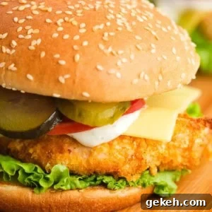 Crispy Air Fryer Chicken Sandwich Recipe 19 Crispy air fryer chicken sandwich with pickles, mayo, tomatoes, red onions, and lettuce on a bun