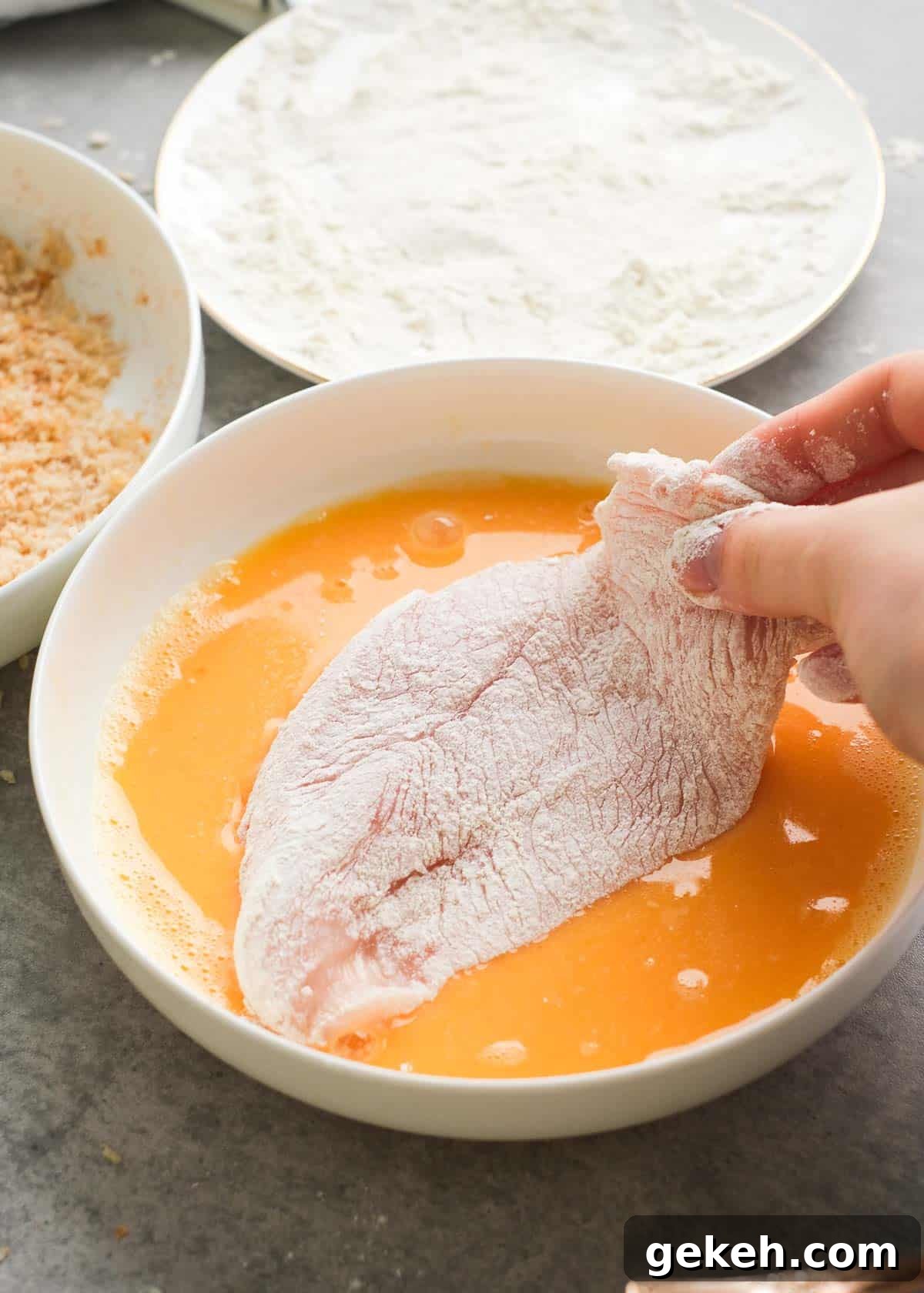 Crispy Air Fryer Chicken Sandwich Recipe 7 a floured fillet being dredged in egg