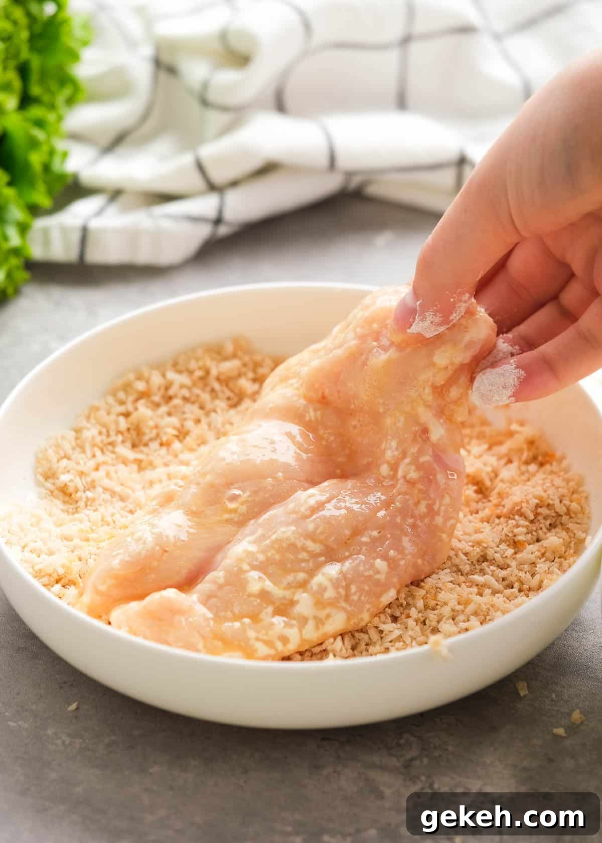 Crispy Air Fryer Chicken Sandwich Recipe 8 an egg-drenched chicken fillet being pressed into seasoned bread crumbs and parmesan cheese