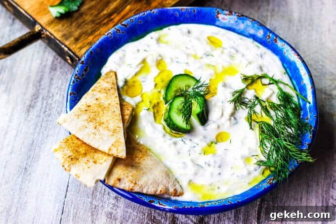 Traditional Greek Tzatziki Recipe combines real thick greek yogurt, seedless cucumber, garlic, dill and splash of vinegar and olive oil. It's a perfect sauce that can be paired with any meals like: grilled meats, vegetables, sandwiches, pitas or salads.