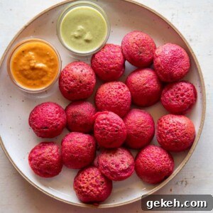 Beetroot Paniyaram served on a plate with coconut chutney and tomato chutney