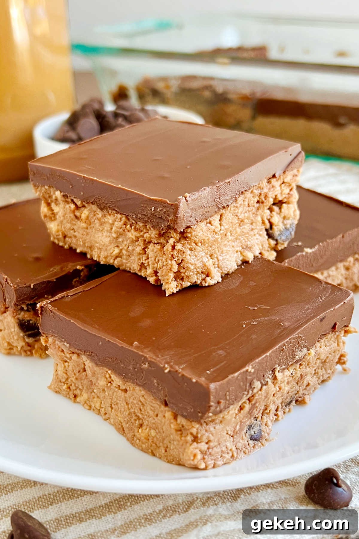 no bake chocolate peanut butter bars with chocolate chips on plate.