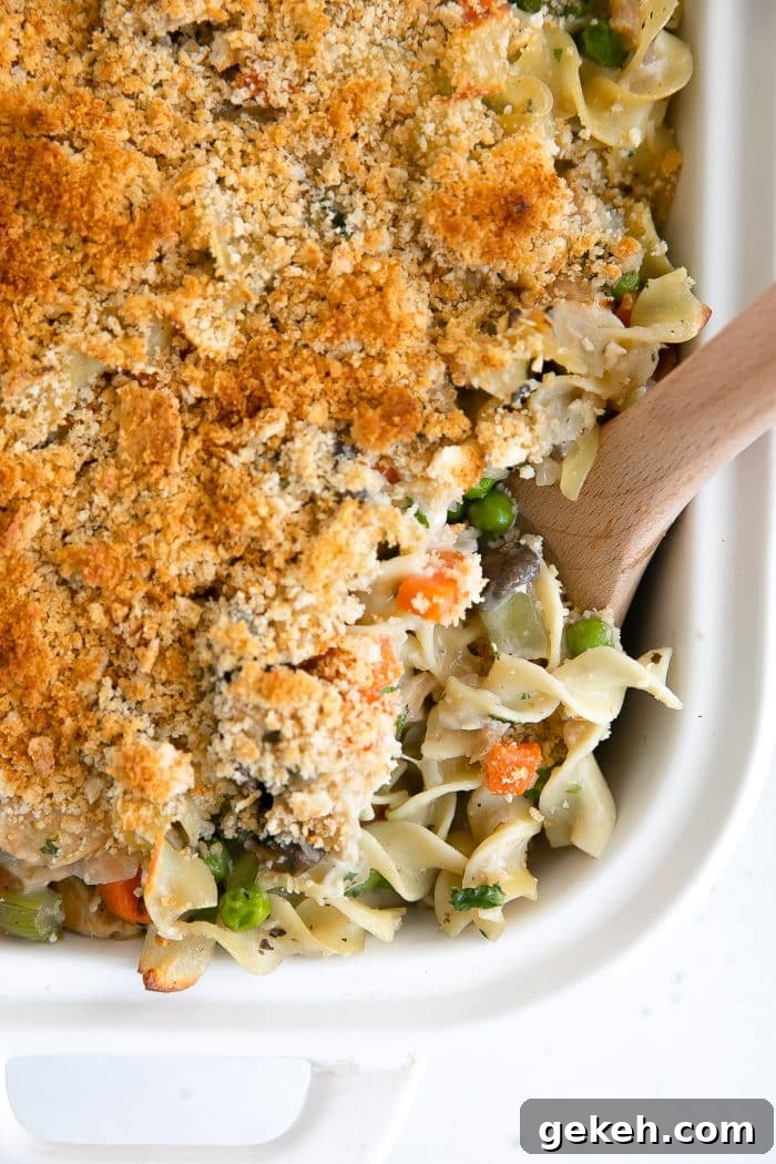 Crispy golden casserole made with canned tuna, noodles, and a homemade sauce with frozen peas and carrots.