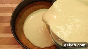 Creamy Lemon Cheesecake Recipe: Zesty Slice of Perfection 12 pouring cream cheese filling