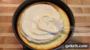 Creamy Lemon Cheesecake Recipe: Zesty Slice of Perfection 13 sour cream mixture on cheesecake