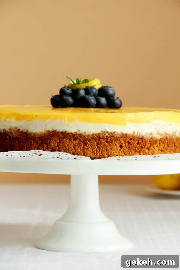 Creamy Lemon Cheesecake Recipe: Zesty Slice of Perfection 4 cheesecake with lemon curd on cake stand