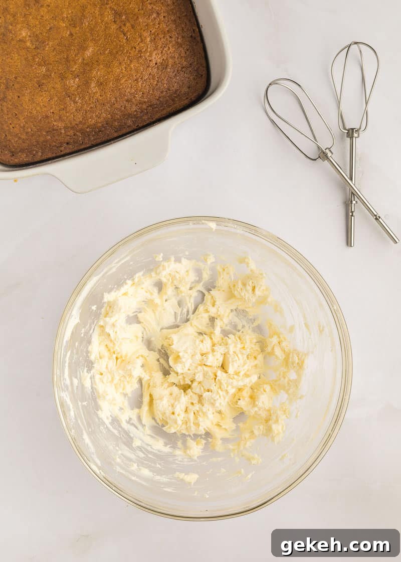 Moist Pumpkin Sheet Cake Recipe with Cream Cheese Frosting 16 A glass bowl with butter, cream cheese and vanilla whisked together.