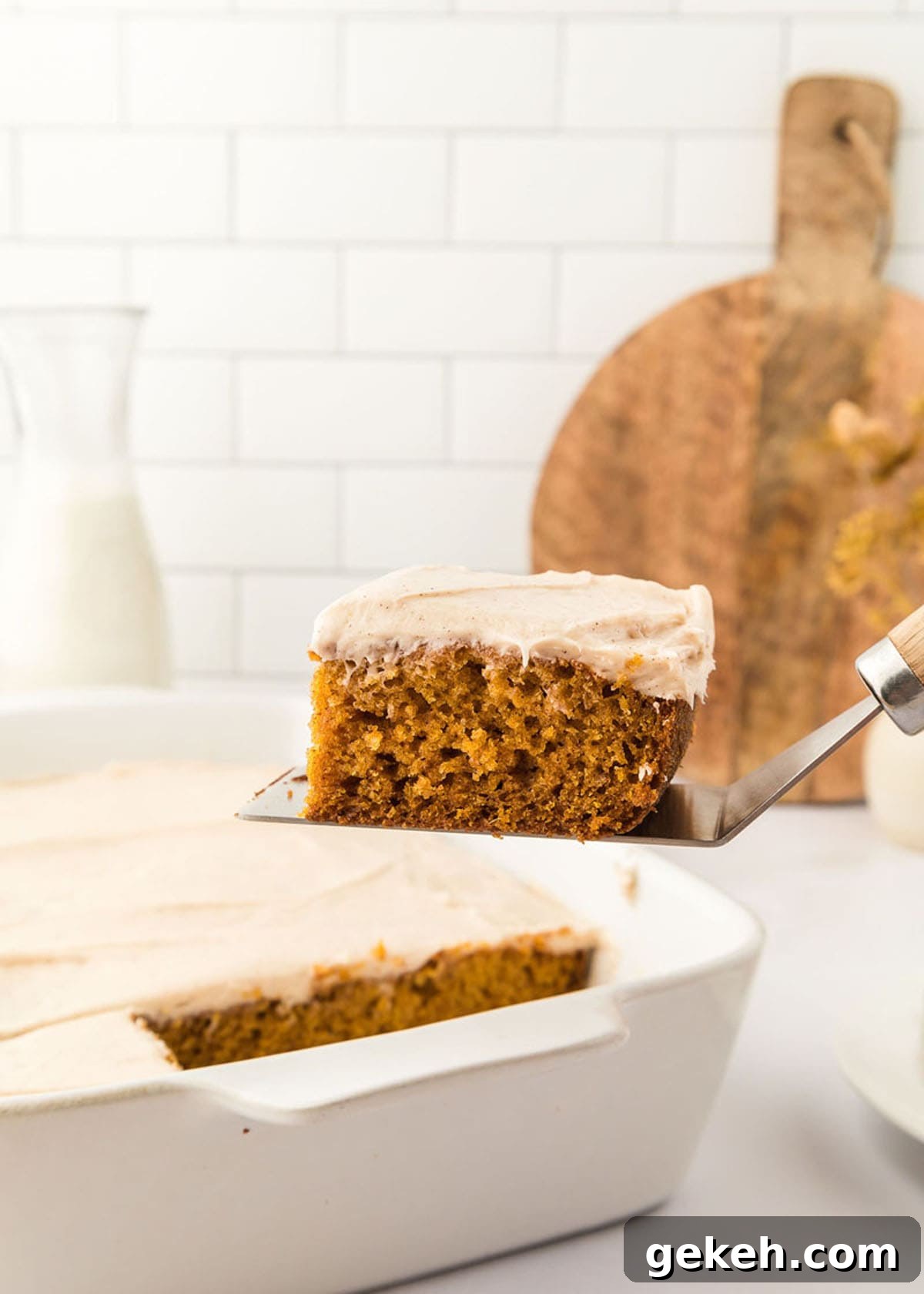 Moist Pumpkin Sheet Cake Recipe with Cream Cheese Frosting 3 A slice of pumpkin cake with maple cream cheese frosting.