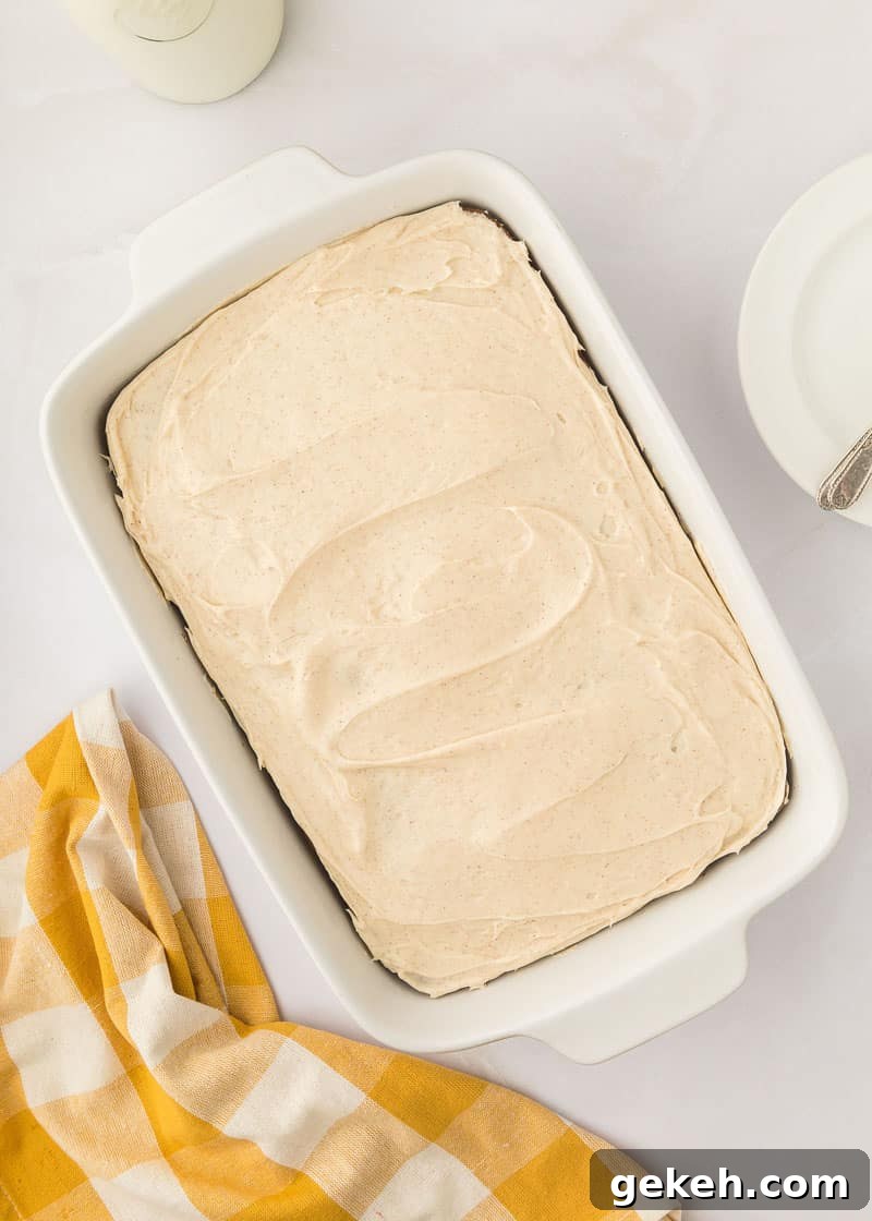 Moist Pumpkin Sheet Cake Recipe with Cream Cheese Frosting 19 Pumpkin cake in a white baking dish.