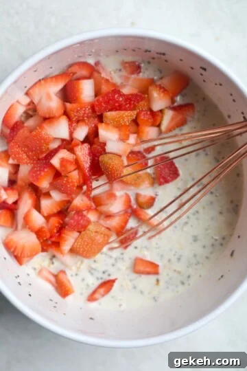 mixed oatmeal with strawberries and whisk