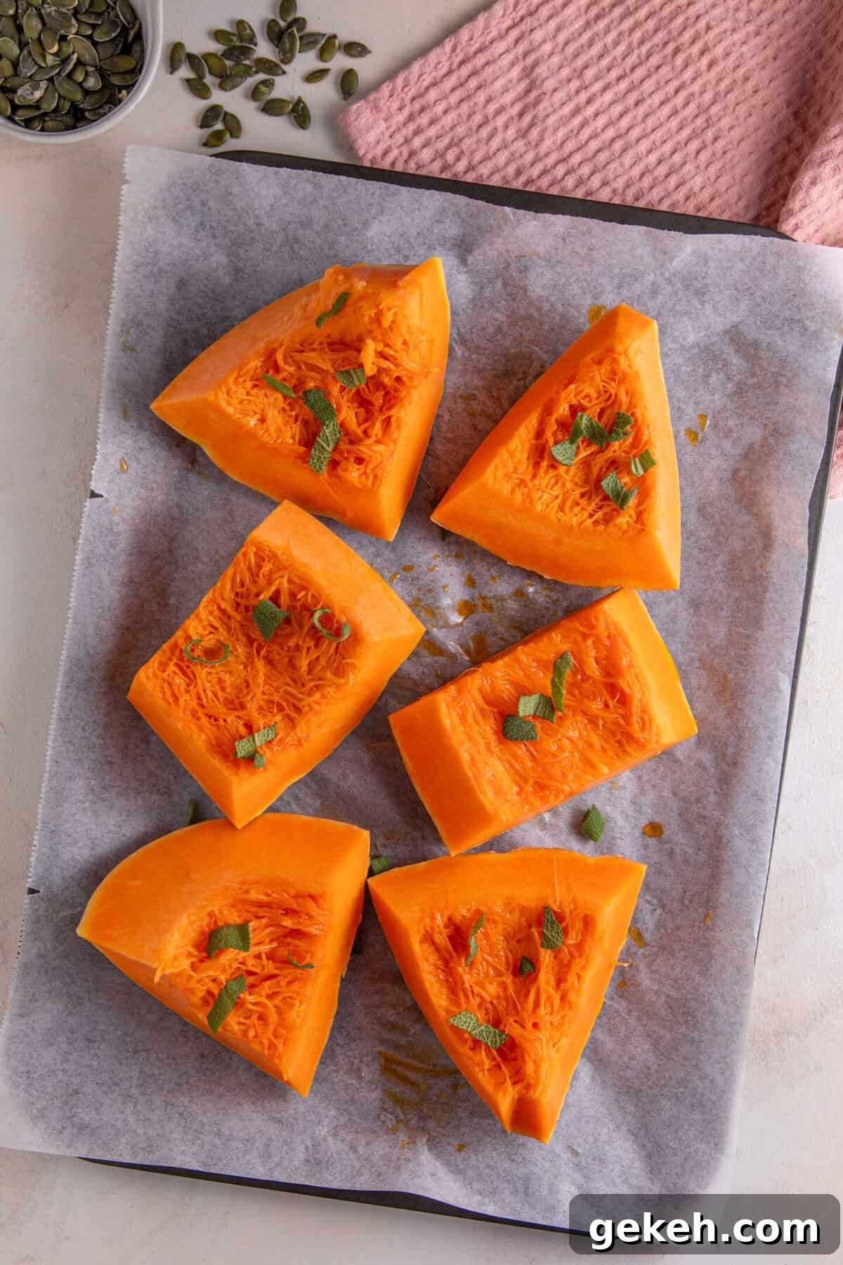 Pumpkin cut into wedges and scattered with sage leaves and chilli oil.