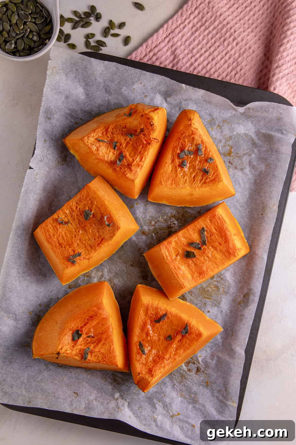 Roasted pumpkin cut into wedges and scattered with sage leaves and chilli oil.