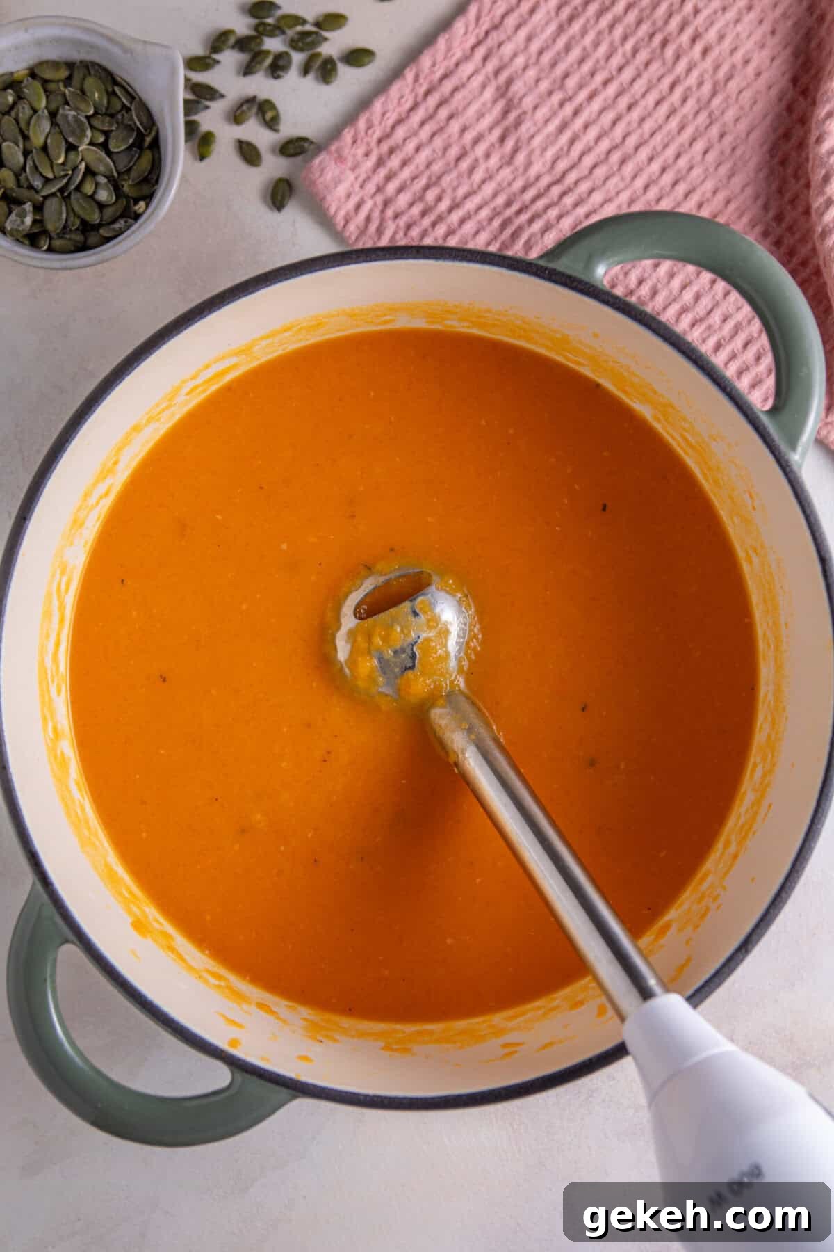 Add the vegetable stock then blend the soup until smooth.