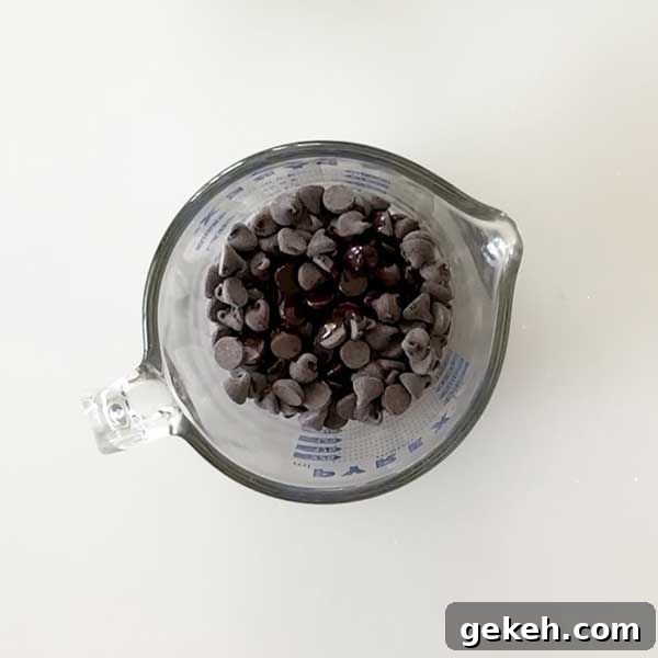 Adding the chocolate chips to a microwave safe bowl with coconut oil.
