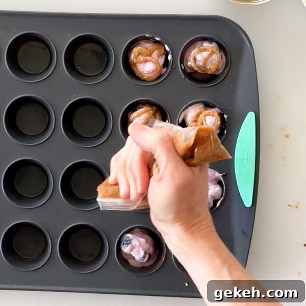 Spreading the caramel sauce over the blueberry yogurt clusters.