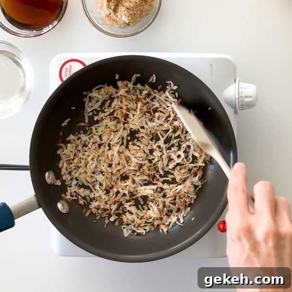Mixing the toasted coconut in the skillet.