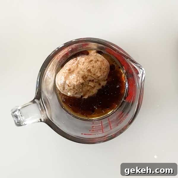 Adding the caramel ingredients to a glass measuring bowl.