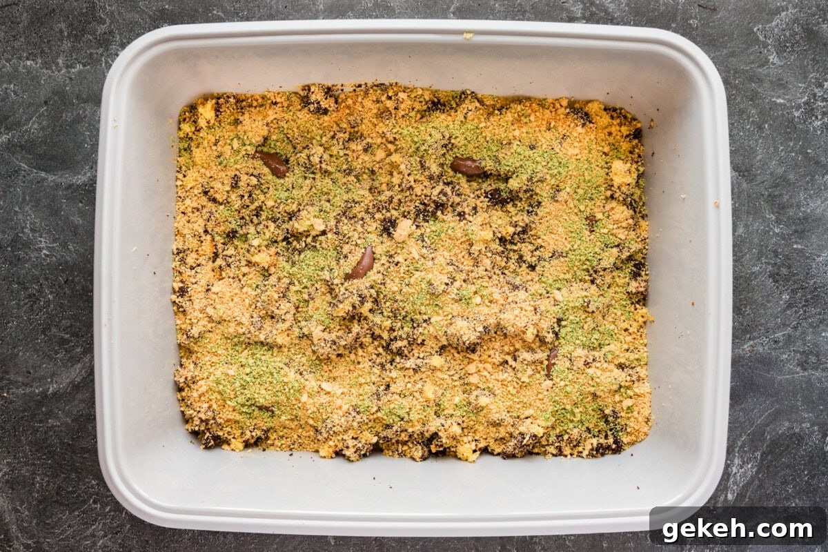 green tined cookie crumbles on top of kitty litter cake