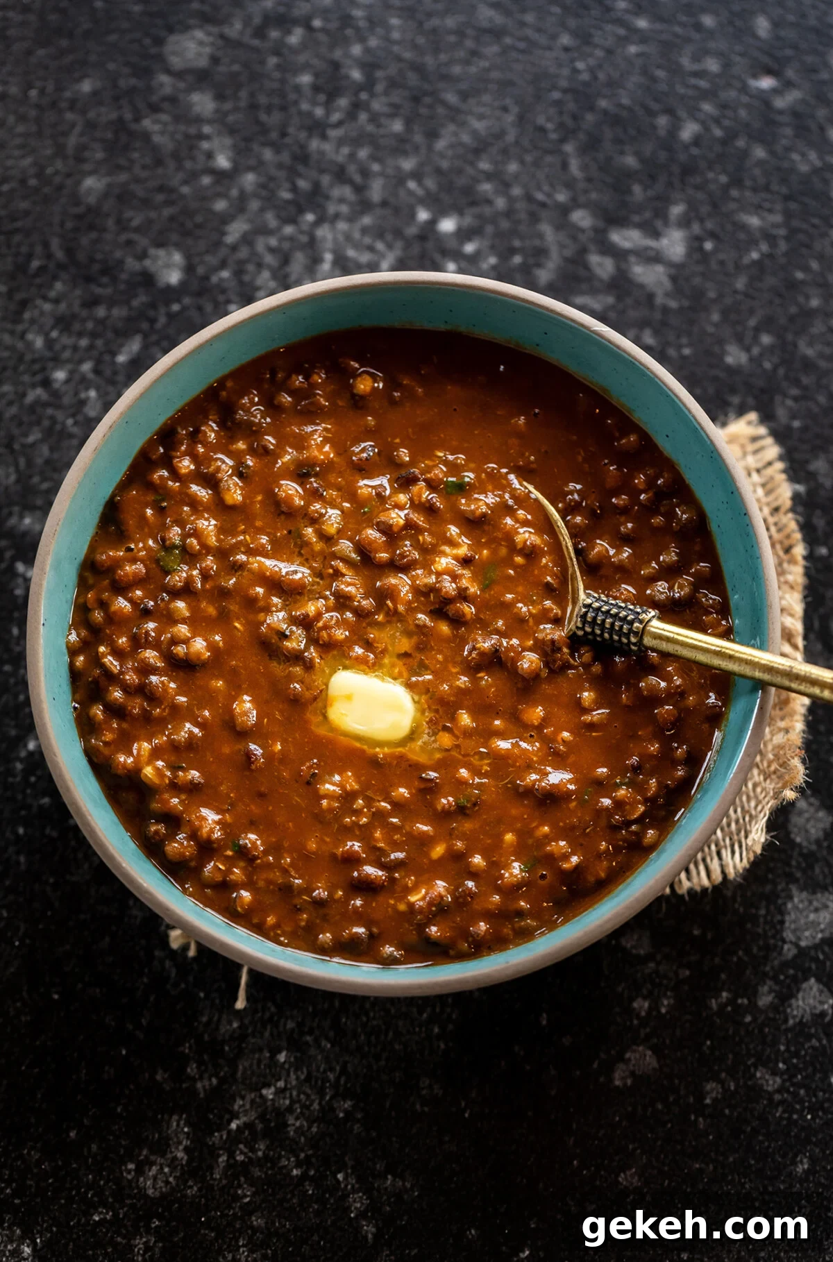 urad dal served with butter in a blue color bowl