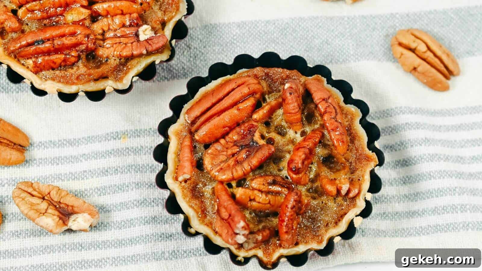 19 Desserts for Two to Share Straight from the Pan 10 Mini pecan pie tarts on a striped cloth.