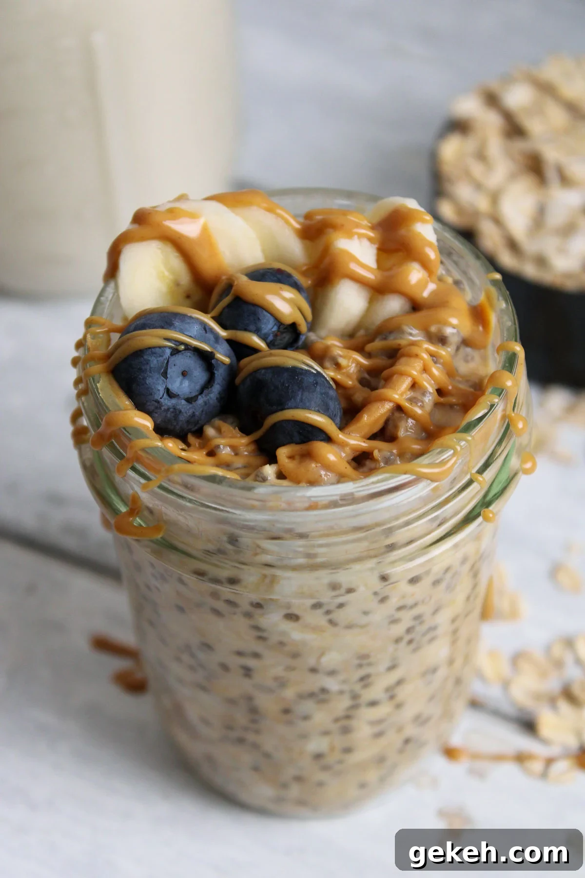 Creamy Peanut Butter Overnight Oats Recipe for Quick Breakfast 2 Overnight oats with peanut butter topped with blueberries and sliced bananas.