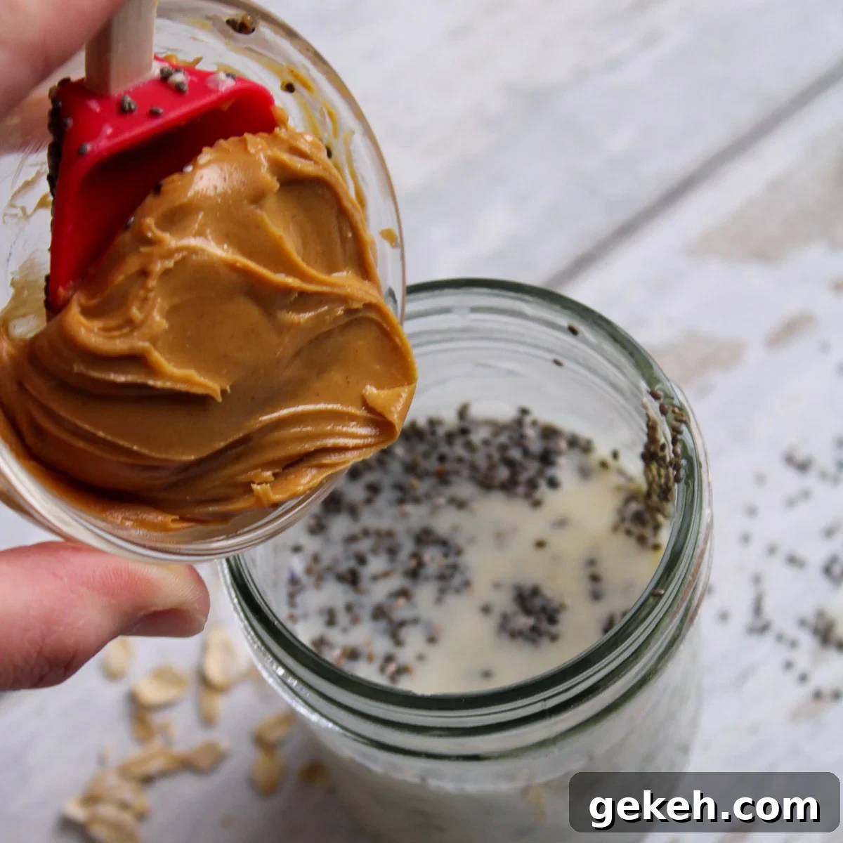 Creamy Peanut Butter Overnight Oats Recipe for Quick Breakfast 5 Adding peanut butter to the jar with milk, chia seeds, and honey.