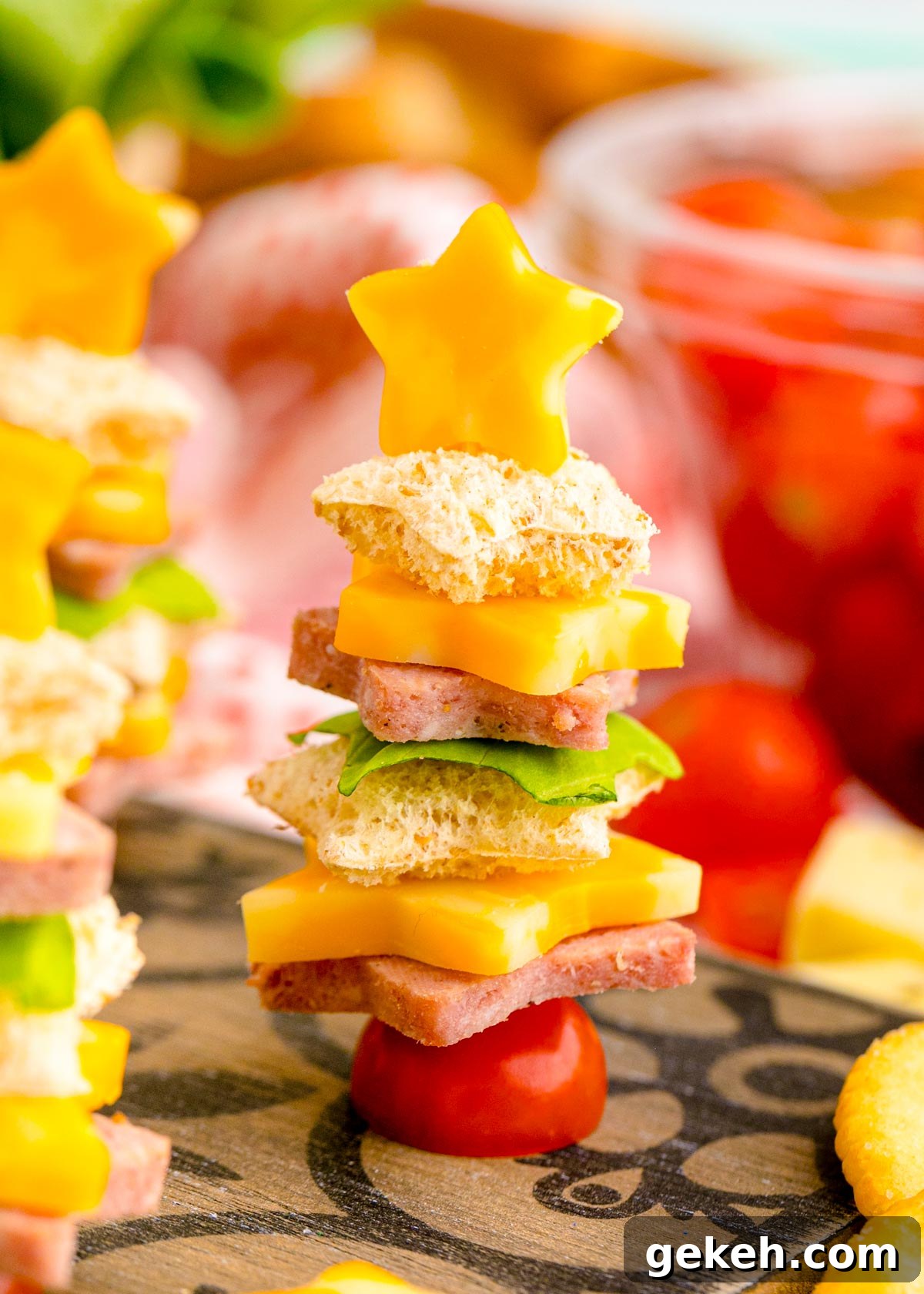Festive Christmas Appetizer Ideas for Holiday Entertaining 2 Close up photo of cute christmas appetizers made with bread and deli meat and cheese to look like christmas trees.