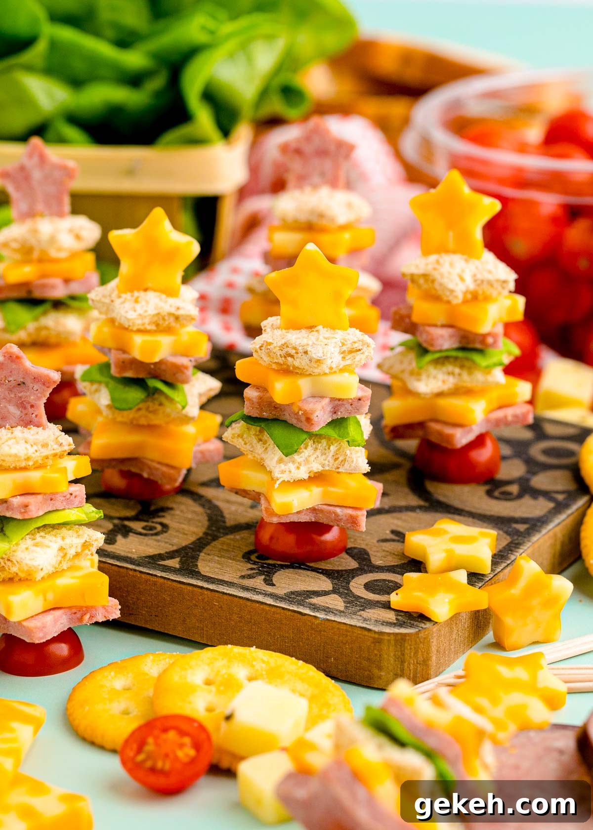 Festive Christmas Appetizer Ideas for Holiday Entertaining 3 Easy Christmas tree shaped appetizers on a wooden cutting board ready to be served.