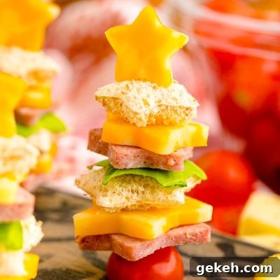 Festive Christmas Appetizer Ideas for Holiday Entertaining 7 Close up photo of cute christmas appetizers made with bread and deli meat and cheese to look like christmas trees.
