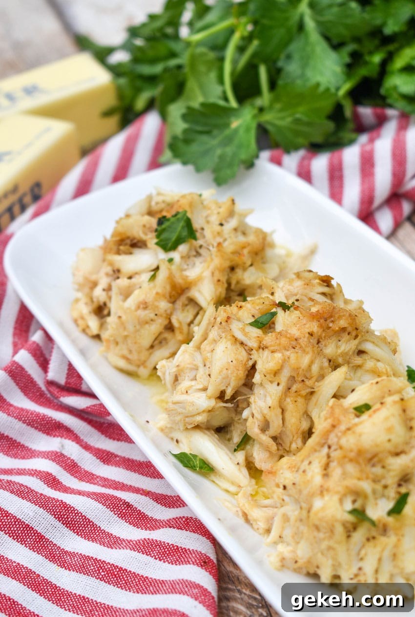 Jerry’s Place Baked Lump Crab Cakes Recipe (Copycat) 8 three baked lump crab cakes on a narrow white serving plate