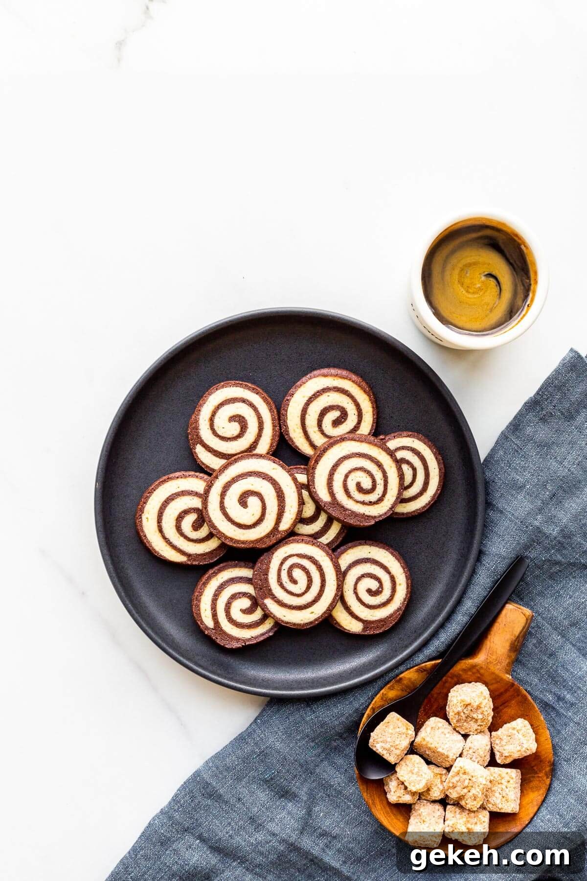 Chocolate Pinwheel Cookies: Swirl Cookie Recipe for Parties 2 A plate of chocolate pinwheel cookies served with a cup of coffee and a bowl sugar cubes.