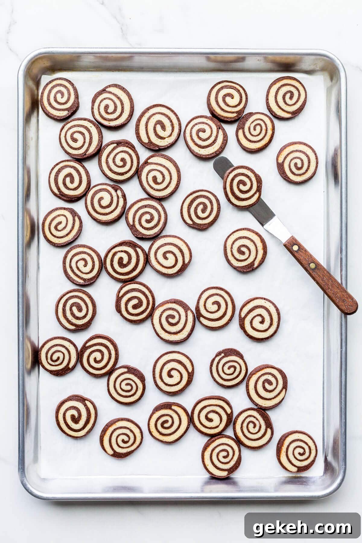 Chocolate Pinwheel Cookies: Swirl Cookie Recipe for Parties 9 A sheet pan of freshly baked chocolate and vanilla pinwheel cookies.