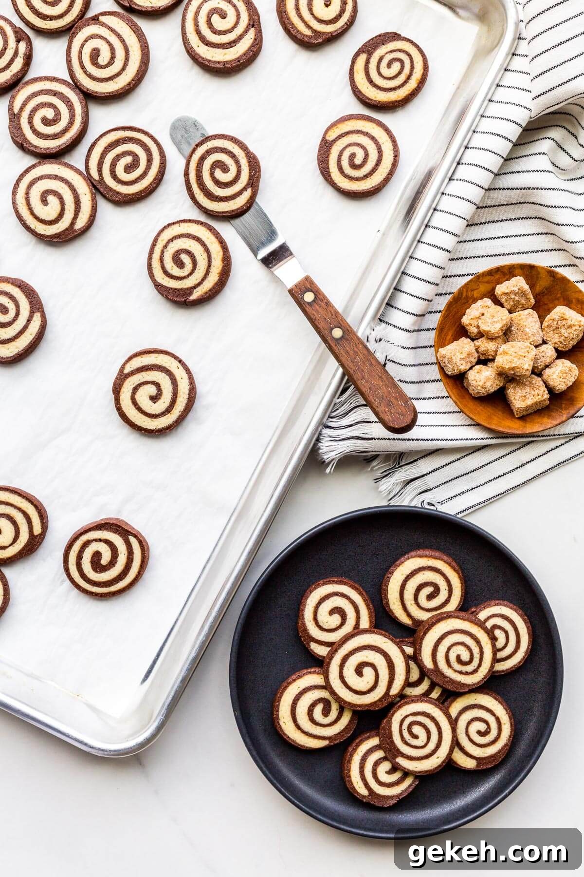 Chocolate Pinwheel Cookies: Swirl Cookie Recipe for Parties 10 Transferring pinwheel cookies from a sheet pan to a plate to serve them.