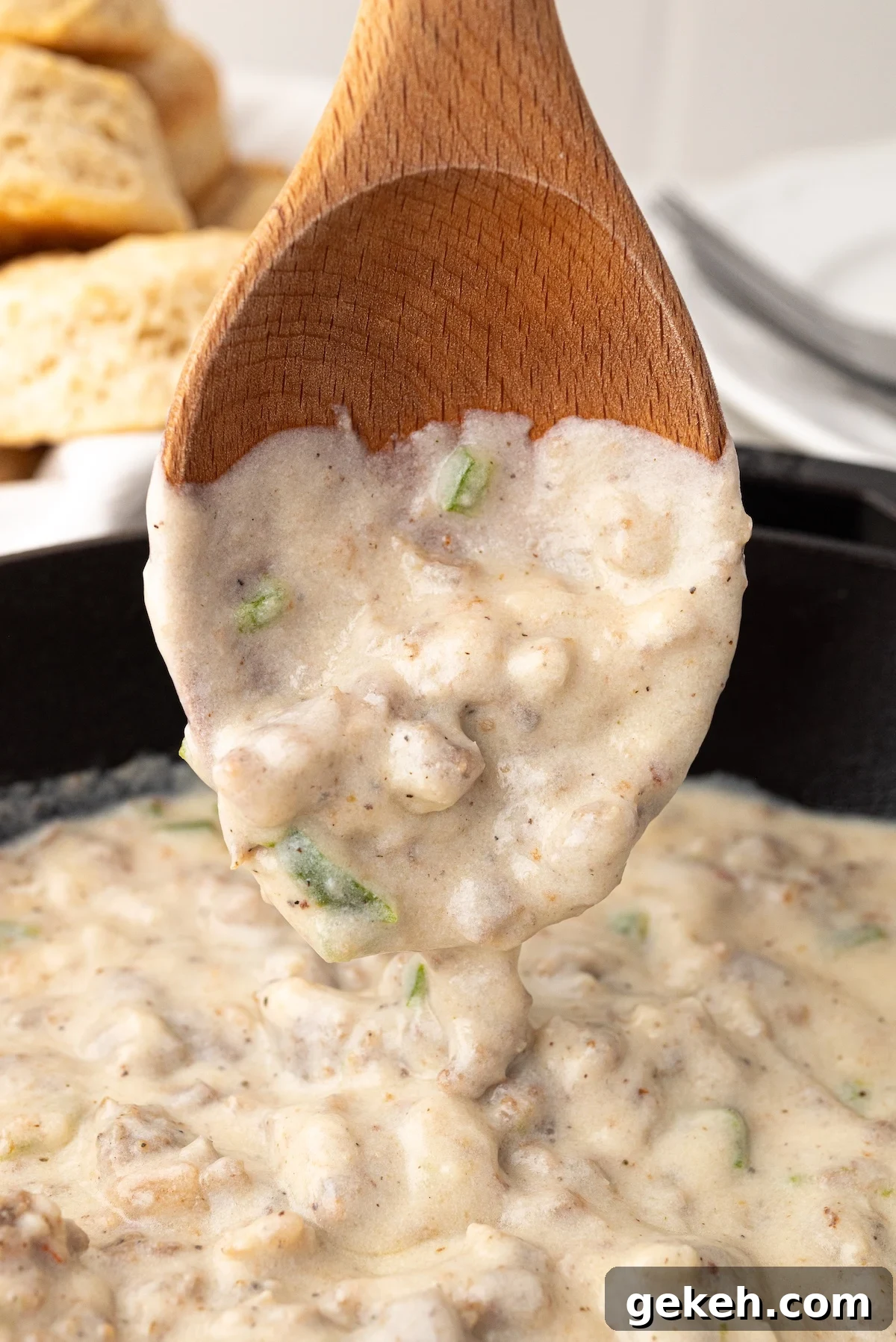 Jalapeño Sausage Gravy Recipe for Spicy Southern Biscuits 4 wooden spoon with creamy jalapeno sausage gravy