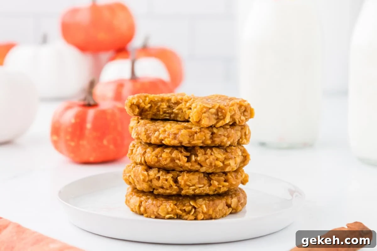 No-Bake Pumpkin Oat Cookies: Quick Fall Treats 13 A small stack of pumpkin oatmeal cookies, with fake pumpkins in the background.