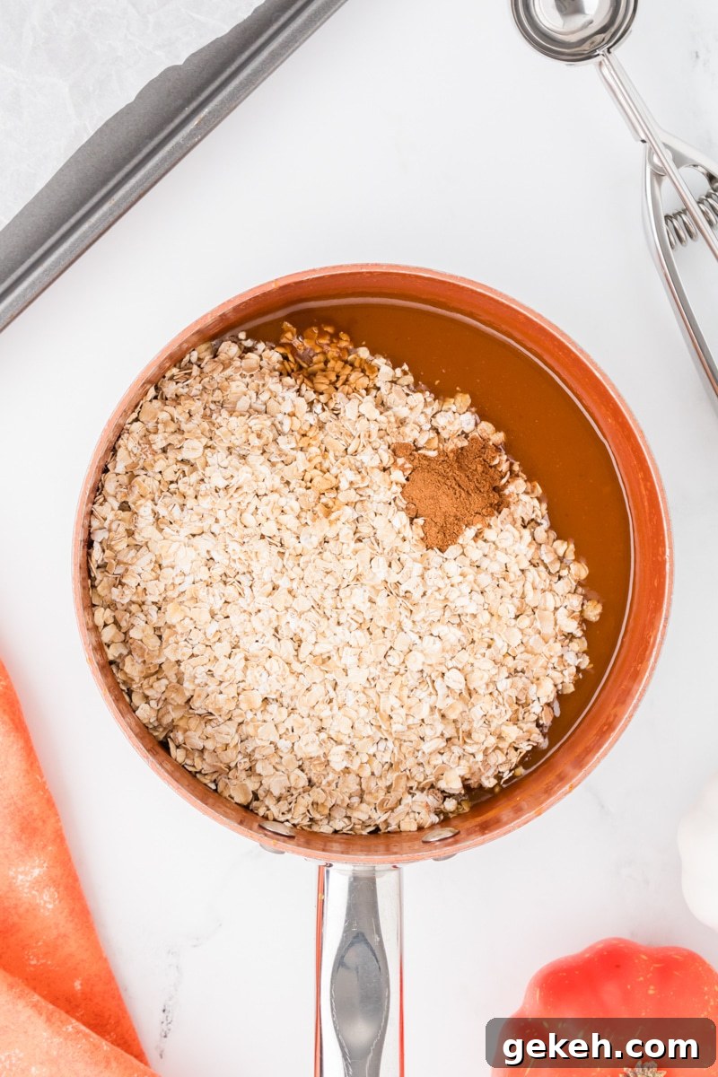 No-Bake Pumpkin Oat Cookies: Quick Fall Treats 6 A saucepan with quick oats and pumpkin spice added in.