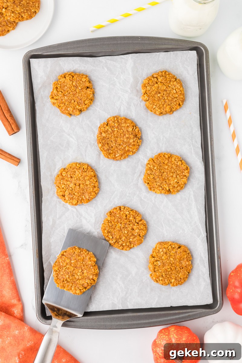 No-Bake Pumpkin Oat Cookies: Quick Fall Treats 10 A baking sheet filled with pumpkin oatmeal cookies.
