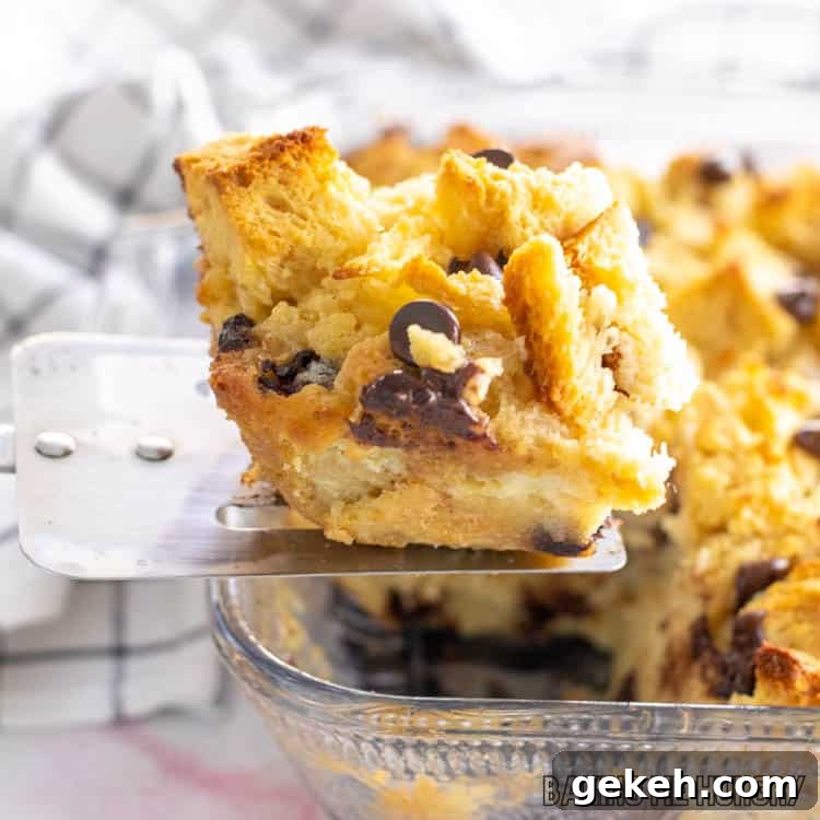 serving spatula lifting up a piece of the chocolate chip bread pudding