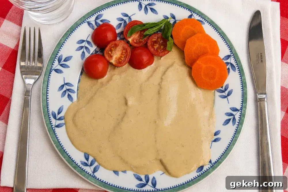 Vitello Tonnato: Classic Italian Cold Veal with Tuna-Caper Sauce 3 Vitello Tonnato covered with creamy tuna sauce and decorated with carrot slices and cherry tomatoes.