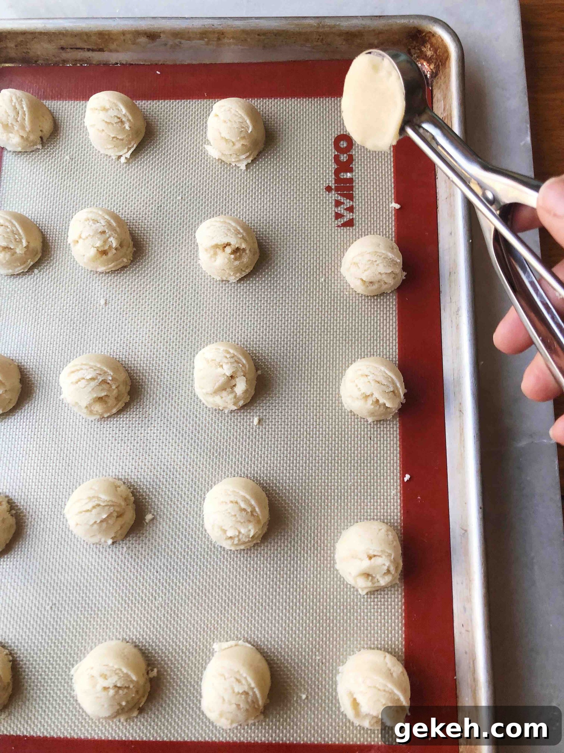 Pressed Almond Sugar Cookies — Crisp, Buttery Almond Slices 3 scoop of cookie dough with pan of cookie balls