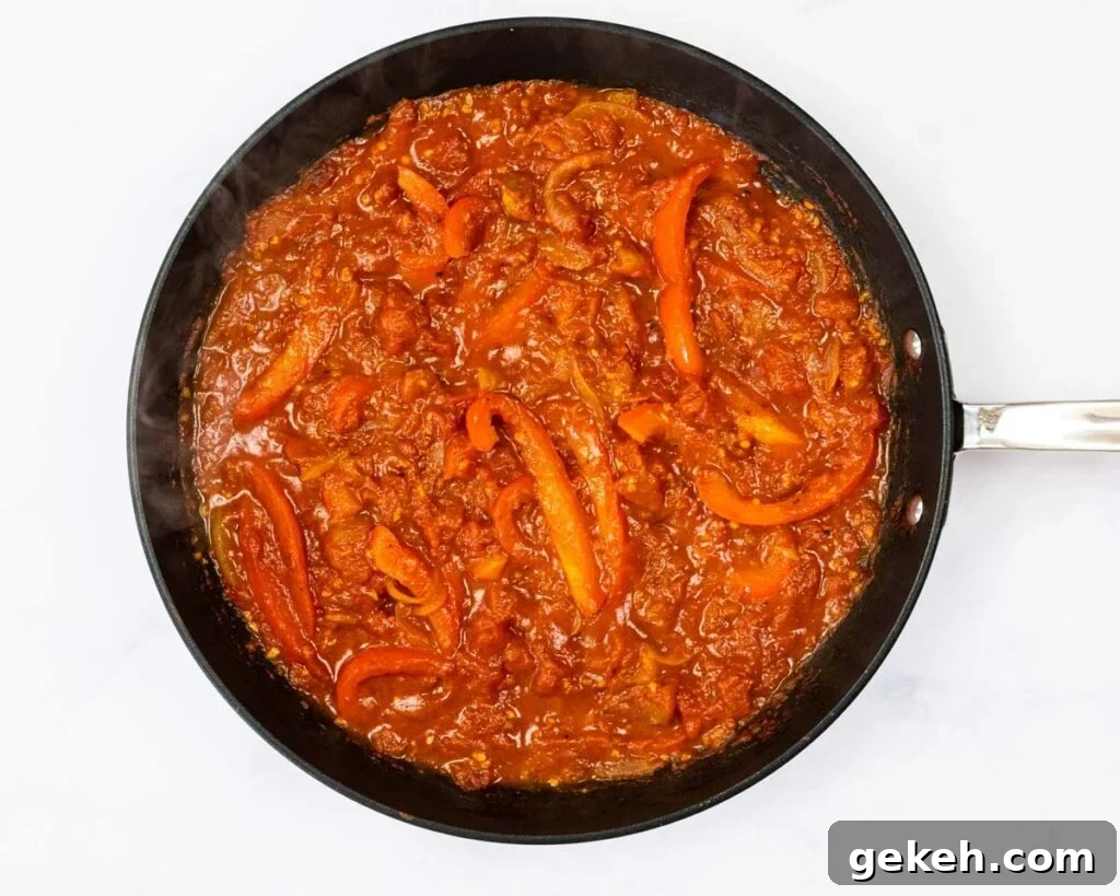 Reduced tomato sauce in a skillet.