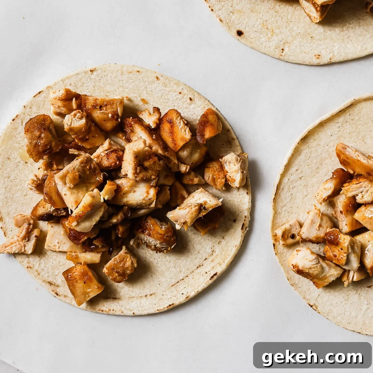 Chicken Tacos with Savory Homemade Marinade 9 Diced chicken piled on top of warm corn tortillas.