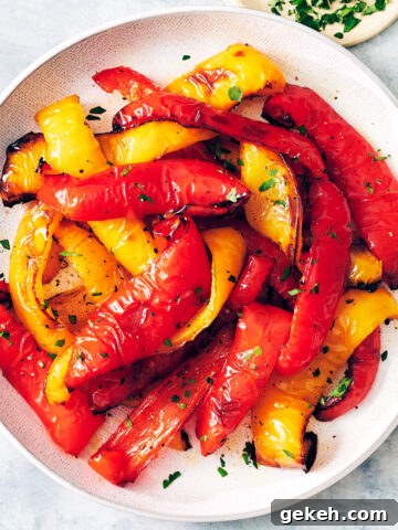 Air fryer peppers topped with parsley on a plate.