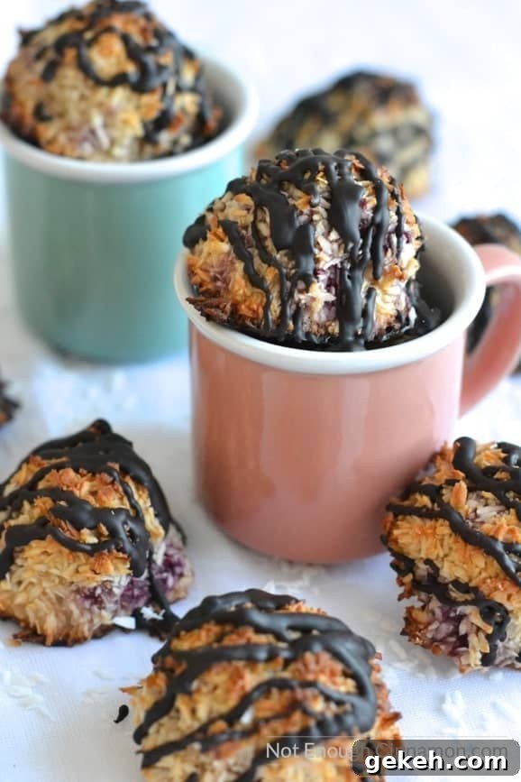 Refined sugar free, gluten free raspberry, chocolate coconut macaroons arranged in two pastel coloured espresso cups 