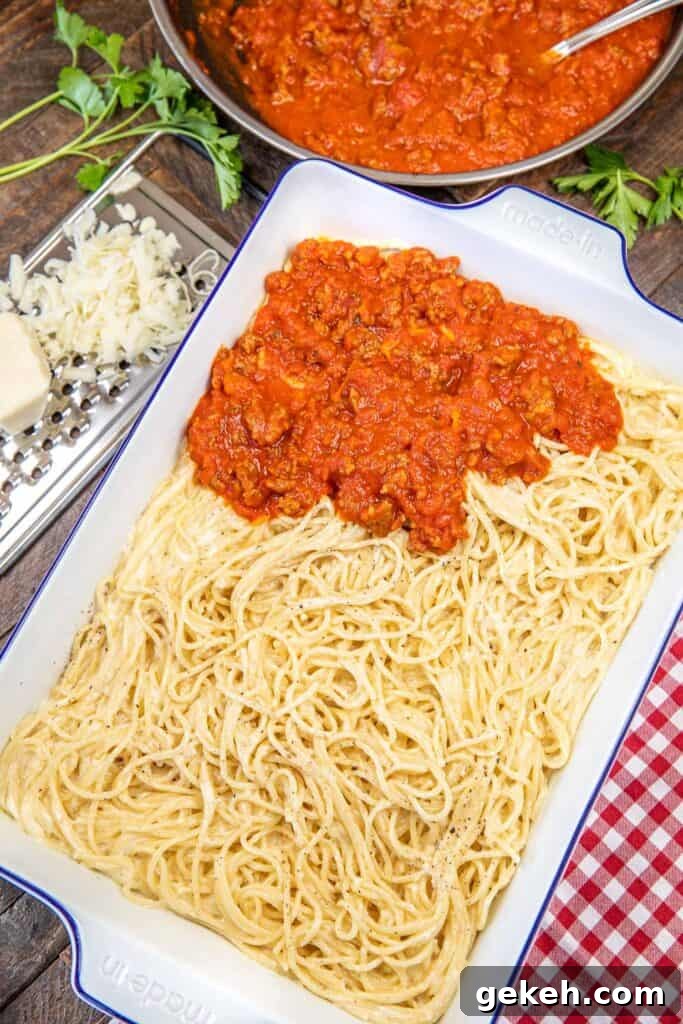 TikTok’s Viral Spaghetti Alfredo Recipe: Creamy 15-Minute Dish 3 baking dish of spaghetti alfredo topped with red sauce